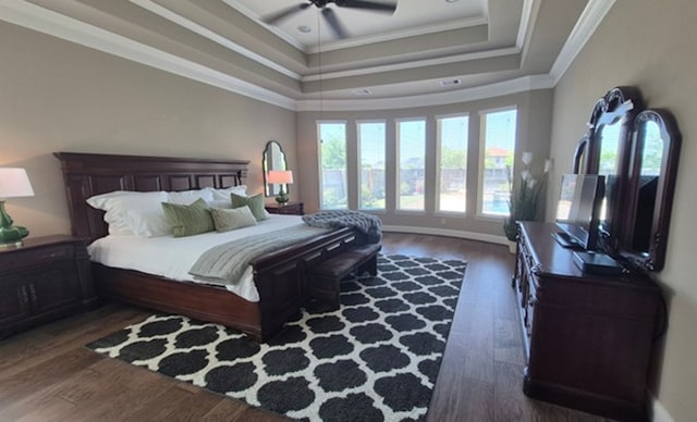 7106 Prairie Grass Ln, Katy, TX 77493 - bedroom with ornamental molding, a tray ceiling, dark wood finished floors, and a ceiling fan