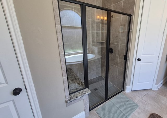 7106 Prairie Grass Ln, Katy, TX 77493 - full bath with a shower stall, tile patterned flooring, french doors, and a bathtub