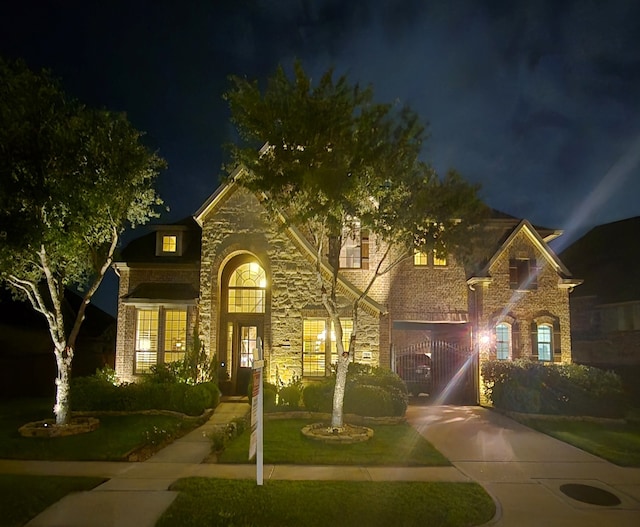 7106 Prairie Grass Ln, Katy, TX 77493 - traditional home with brick siding, stone siding, and a yard
