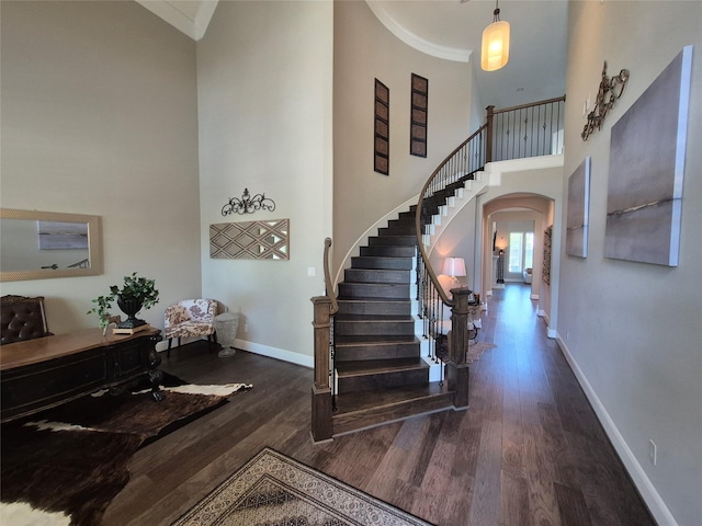7106 Prairie Grass Ln, Katy, TX 77493 - foyer entrance with ornamental molding, a high ceiling, wood finished floors, arched walkways, and stairway
