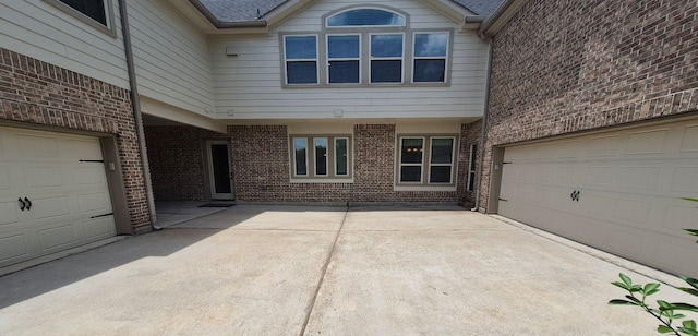 7106 Prairie Grass Ln, Katy, TX 77493 - view of exterior entry featuring brick siding, a garage, and driveway