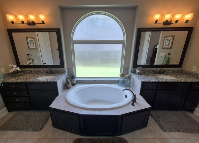 7106 Prairie Grass Ln, Katy, TX 77493 - bathroom featuring two vanities, a garden tub, and healthy amount of natural light