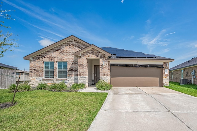 903 Curly Angora Ct, Rosharon, TX 77583 - view of front of house featuring stone siding, driveway, solar panels, brick siding, and a garage