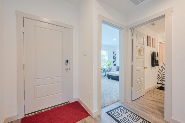 903 Curly Angora Ct, Rosharon, TX 77583 - entryway with light wood-style floors and baseboards