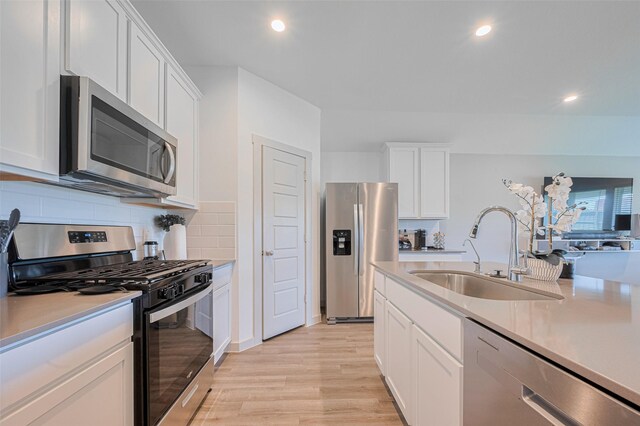 903 Curly Angora Ct, Rosharon, TX 77583 - kitchen with stainless steel appliances, light countertops, white cabinets, tasteful backsplash, and recessed lighting