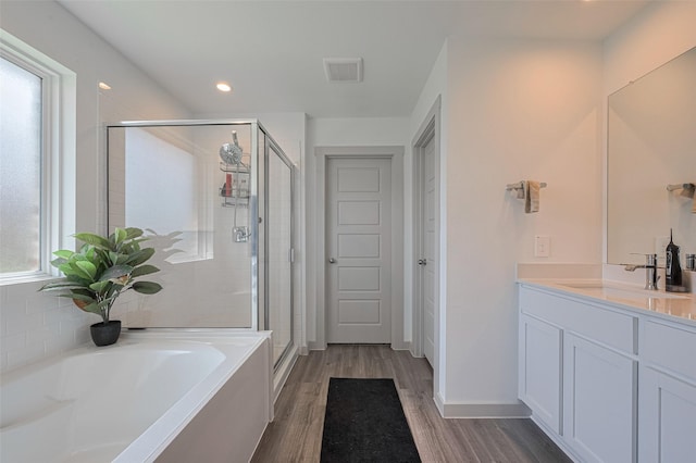 903 Curly Angora Ct, Rosharon, TX 77583 - full bathroom with a shower stall, a garden tub, vanity, wood finished floors, and recessed lighting