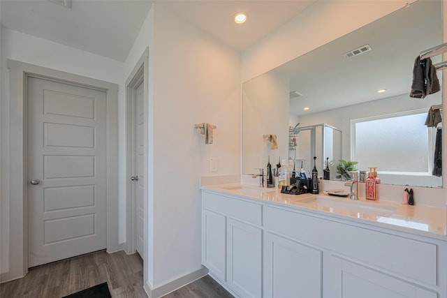 903 Curly Angora Ct, Rosharon, TX 77583 - bathroom with wood finished floors, a shower stall, double vanity, and recessed lighting