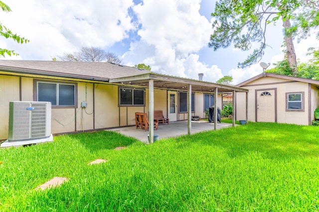 9938 Rustic Rock Rd, La Porte, TX 77571 - rear view of property with a patio area, a lawn, and an outbuilding