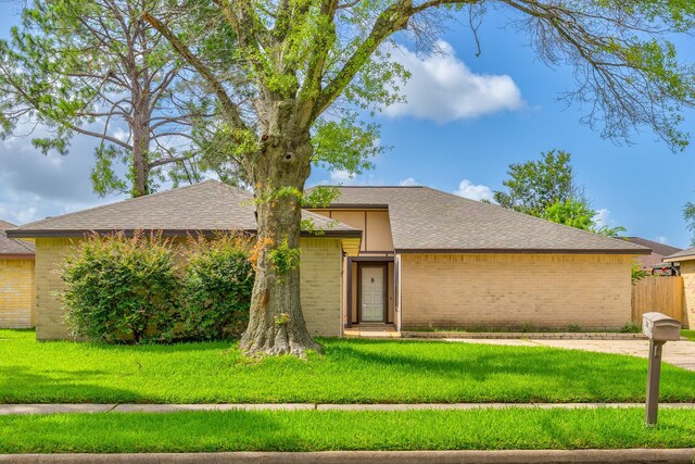 9938 Rustic Rock Rd, La Porte, TX 77571 - view of front facade featuring brick siding and a shingled roof