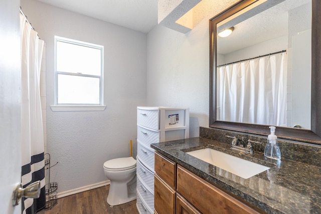 9938 Rustic Rock Rd, La Porte, TX 77571 - bathroom with wood finished floors, vanity, and a textured wall
