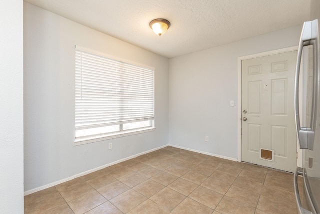 9938 Rustic Rock Rd, La Porte, TX 77571 - empty room with light tile patterned floors and baseboards