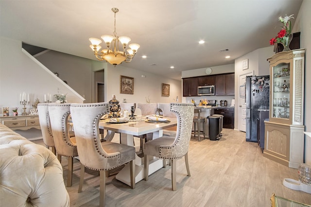 1614 Chase Anchor Ct, Richmond, TX 77469 - dining area with a chandelier, light wood-style flooring, and recessed lighting