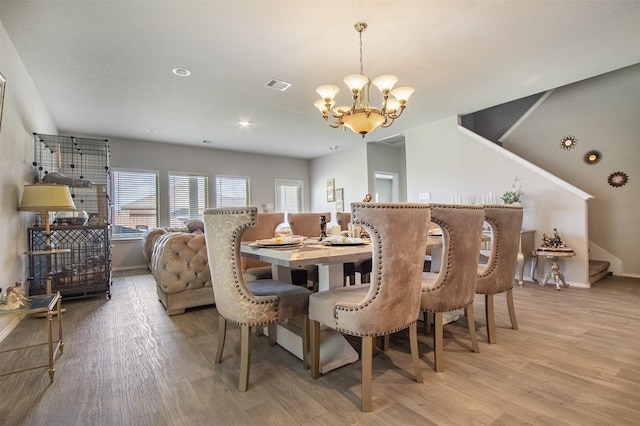 1614 Chase Anchor Ct, Richmond, TX 77469 - dining space with a chandelier, light wood-style floors, and stairs