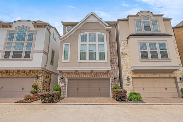 8324 Ginger Oak St, Houston, TX 77055 - view of property with stucco siding, decorative driveway, and an attached garage