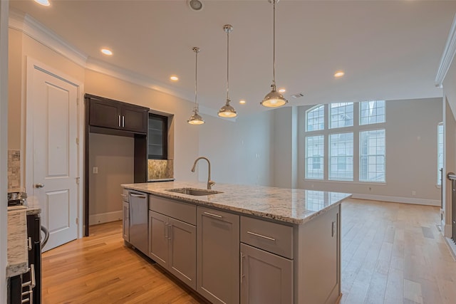 8324 Ginger Oak St, Houston, TX 77055 - kitchen featuring stainless steel dishwasher, light wood-type flooring, a center island with sink, backsplash, and light stone counters