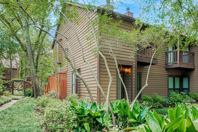 11711 Memorial Dr Unit 213, Houston, TX 77024 - view of home's exterior featuring a balcony and a chimney