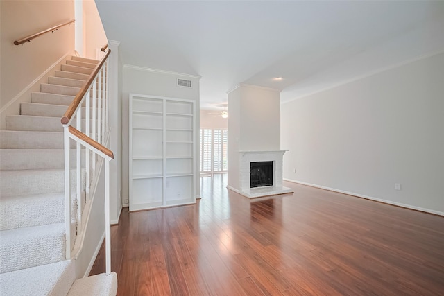 11711 Memorial Dr Unit 213, Houston, TX 77024 - unfurnished living room with a ceiling fan, wood finished floors, ornamental molding, stairs, and a fireplace
