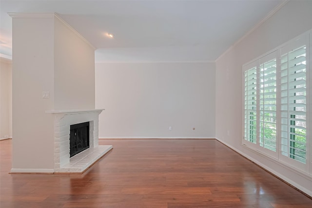 11711 Memorial Dr Unit 213, Houston, TX 77024 - unfurnished living room featuring crown molding, healthy amount of natural light, a brick fireplace, wood finished floors, and recessed lighting