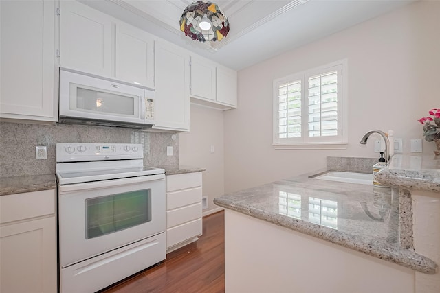 11711 Memorial Dr Unit 213, Houston, TX 77024 - kitchen featuring white appliances, backsplash, wood finished floors, and white cabinets