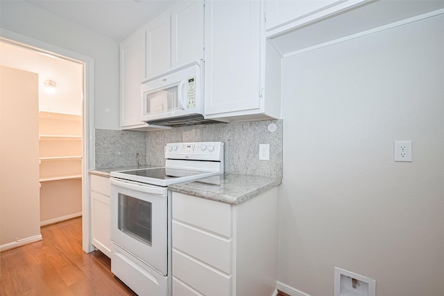 11711 Memorial Dr Unit 213, Houston, TX 77024 - kitchen featuring white appliances, tasteful backsplash, light wood-style flooring, and white cabinetry