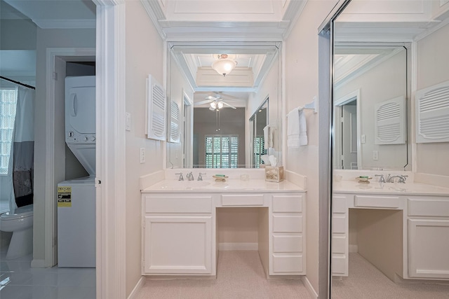 11711 Memorial Dr Unit 213, Houston, TX 77024 - bathroom with stacked washer / drying machine, a ceiling fan, vanity, and ornamental molding