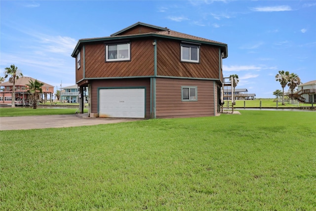 174 Sand Shoals Rd, Freeport, TX 77541 - view of side of home featuring driveway, a lawn, and an attached garage
