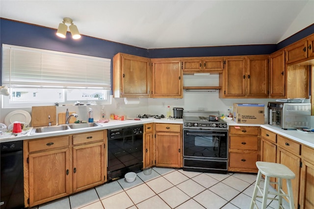 174 Sand Shoals Rd, Freeport, TX 77541 - kitchen featuring black appliances, light countertops, light tile patterned flooring, and brown cabinetry