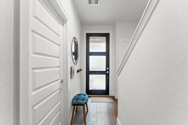 2753 Clinton Dr, Houston, TX 77020 - doorway with dark wood finished floors and a textured wall