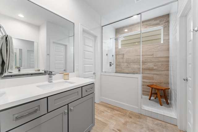 2753 Clinton Dr, Houston, TX 77020 - full bathroom featuring vanity, a walk in shower, and wood finished floors
