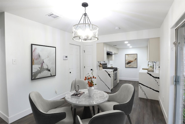 7706 Garsee Dr, Houston, TX 77040 - dining room with dark wood finished floors, a chandelier, and recessed lighting
