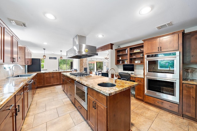 1213 Archley Dr, Hilshire Village, TX 77055 - kitchen with stainless steel appliances, island exhaust hood, a center island with sink, light stone countertops, and a peninsula