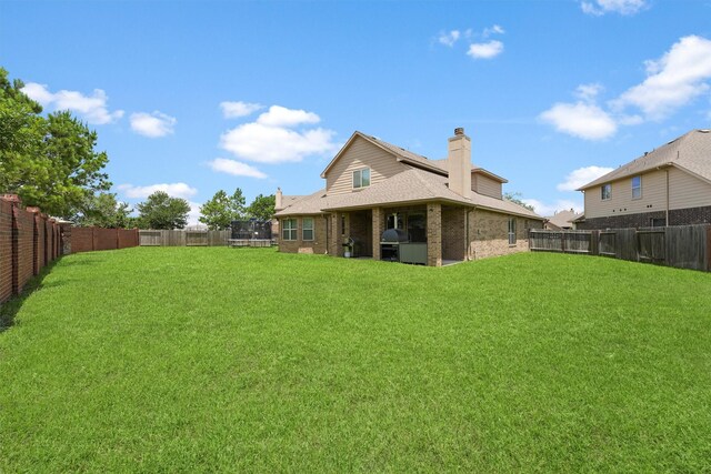 24506 Rossmore Hill Ct, Spring, TX 77389 - fenced backyard featuring a trampoline