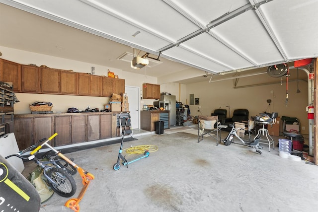 24506 Rossmore Hill Ct, Spring, TX 77389 - garage with a garage door opener and stainless steel fridge