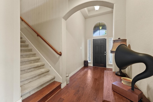24506 Rossmore Hill Ct, Spring, TX 77389 - entryway featuring arched walkways, hardwood / wood-style floors, a towering ceiling, and stairway