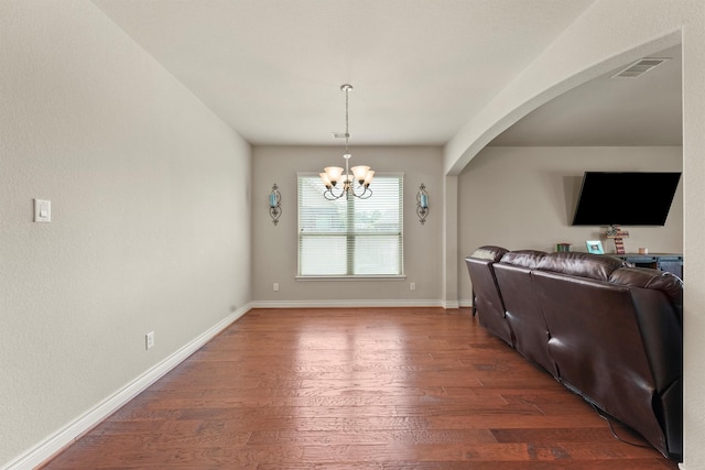 24506 Rossmore Hill Ct, Spring, TX 77389 - living room featuring a chandelier, dark wood-style flooring, and arched walkways