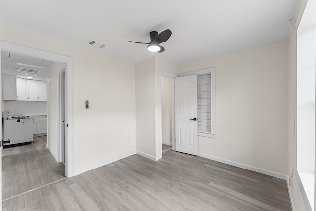 4715 Engleford St, Houston, TX 77026 - spare room with light wood-type flooring, a ceiling fan, and attic access