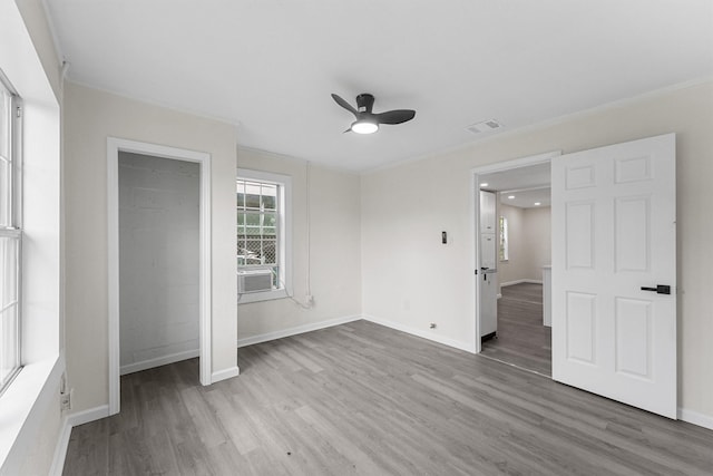 4715 Engleford St, Houston, TX 77026 - unfurnished bedroom with wood finished floors, a ceiling fan, and crown molding