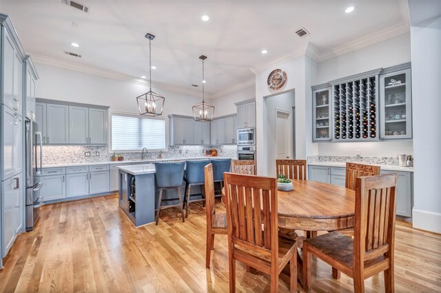 7119 Janet St, Houston, TX 77055 - dining space featuring light wood-style floors, ornamental molding, and recessed lighting