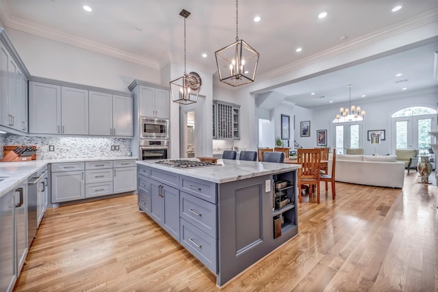 7119 Janet St, Houston, TX 77055 - kitchen with gray cabinets, stainless steel appliances, a chandelier, a center island, and recessed lighting