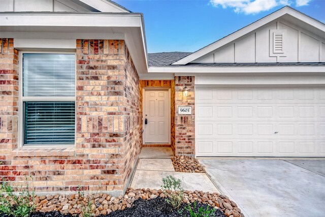 9603 Fulvetta Briar Ct, Baytown, TX 77521 - view of front of house featuring board and batten siding, brick siding, an attached garage, and concrete driveway