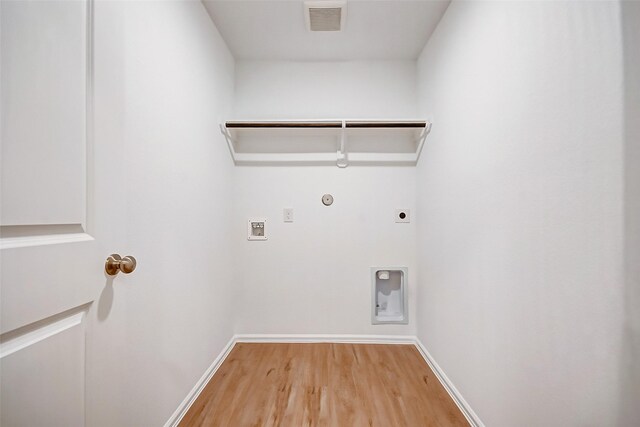 9603 Fulvetta Briar Ct, Baytown, TX 77521 - laundry area featuring gas dryer hookup, electric dryer hookup, wood finished floors, and hookup for a washing machine