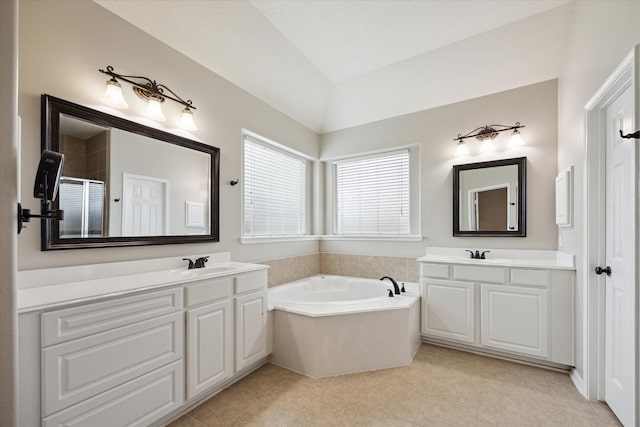 2219 Fenton Rock Ln, Katy, TX 77494 - bathroom with lofted ceiling, a garden tub, two vanities, tile patterned flooring, and a shower with shower door