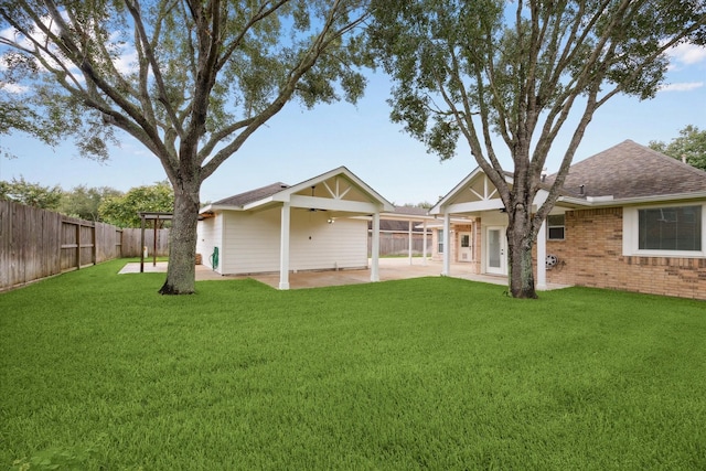 2219 Fenton Rock Ln, Katy, TX 77494 - rear view of house with ceiling fan, a fenced backyard, a patio, roof with shingles, and brick siding