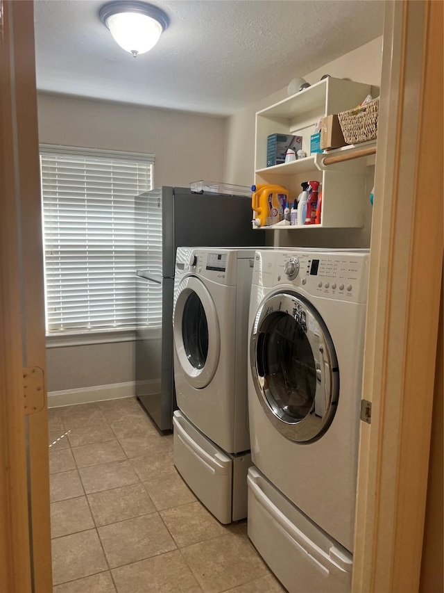 6315 Oakmont Creek Dr, Spring, TX 77379 - laundry area featuring washing machine and clothes dryer and light tile patterned floors
