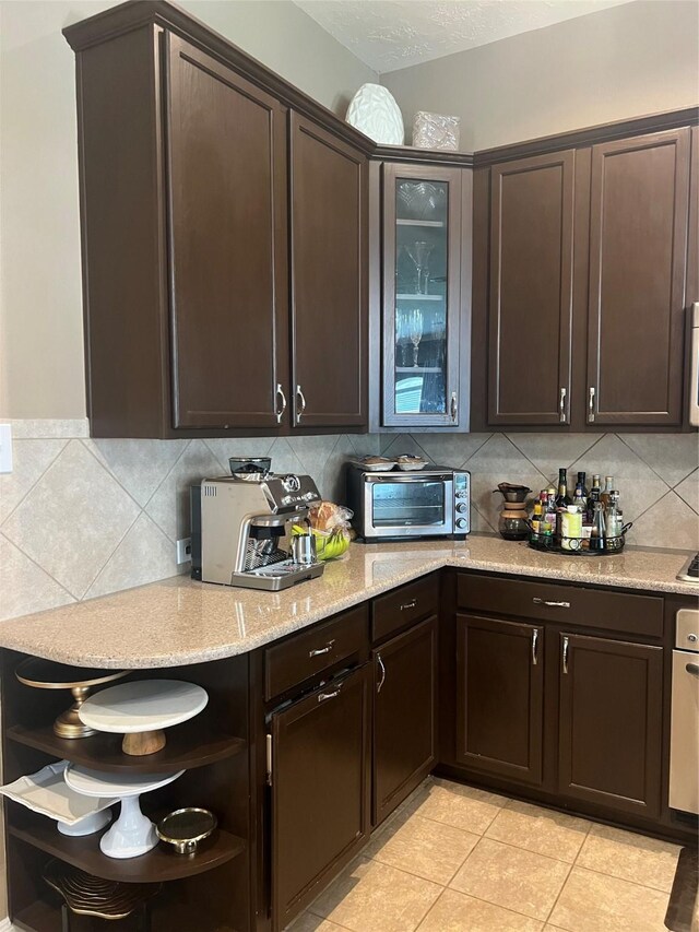 6315 Oakmont Creek Dr, Spring, TX 77379 - kitchen with dark brown cabinets, open shelves, backsplash, and light tile patterned floors