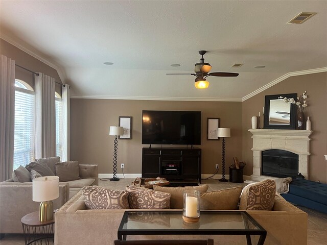 6315 Oakmont Creek Dr, Spring, TX 77379 - living area featuring a glass covered fireplace, a ceiling fan, vaulted ceiling, and ornamental molding