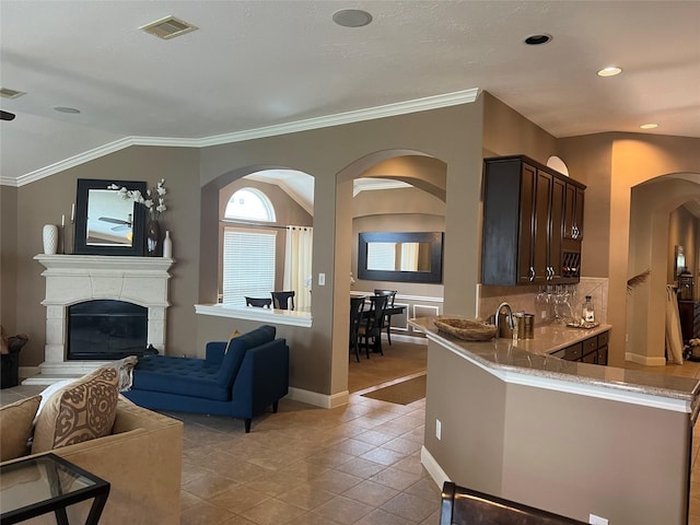 6315 Oakmont Creek Dr, Spring, TX 77379 - living room with arched walkways, a glass covered fireplace, light tile patterned floors, and recessed lighting