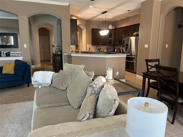 6315 Oakmont Creek Dr, Spring, TX 77379 - living room with arched walkways, recessed lighting, and light tile patterned flooring