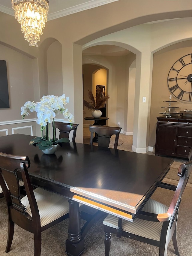 6315 Oakmont Creek Dr, Spring, TX 77379 - dining area featuring arched walkways, ornamental molding, and a chandelier