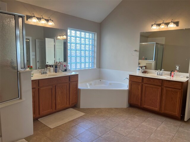 6315 Oakmont Creek Dr, Spring, TX 77379 - full bathroom with lofted ceiling, a shower stall, two vanities, a bath, and tile patterned floors